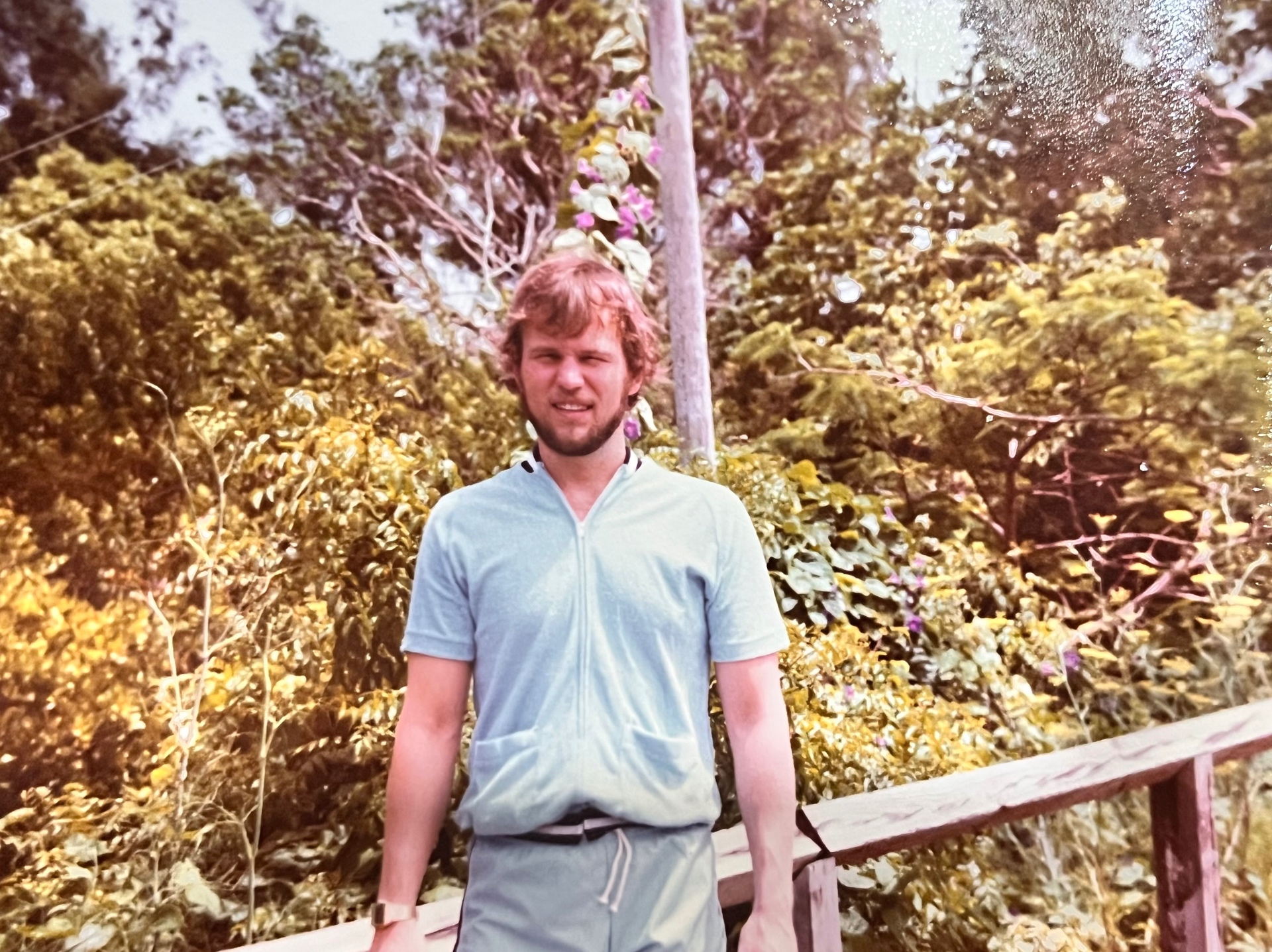 Bermuda bound — Richard sun-warmed and windblown on the boardwalk, bougainvillea behind him. The good years
