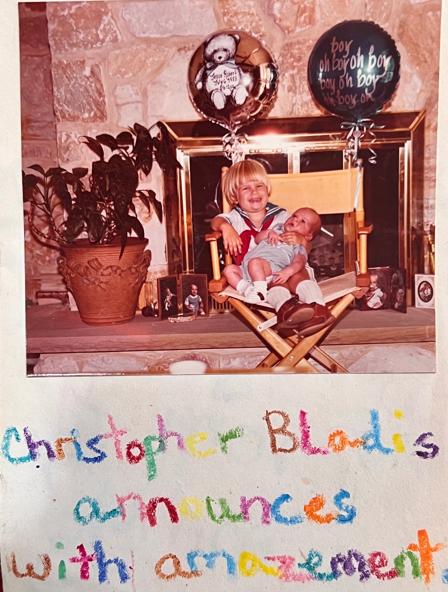 Christopher Bladis, in a little sailor suit, holding his baby brother Jason on the day he came home