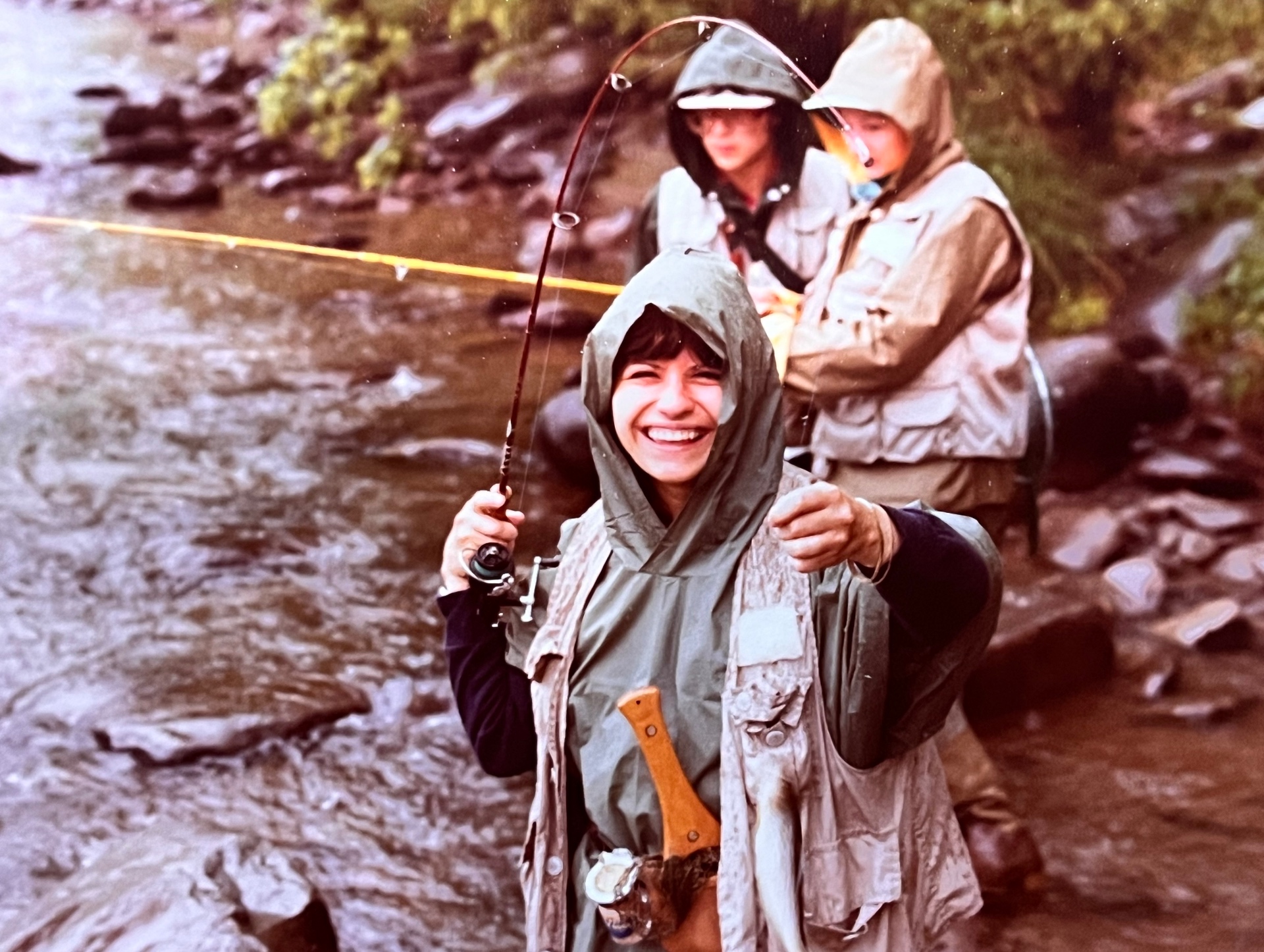 Springfield years — Yvonne beaming in the rain, rod bent, laughing under the hood. Richard behind her with the guys. Every weekend they could get away, they did
