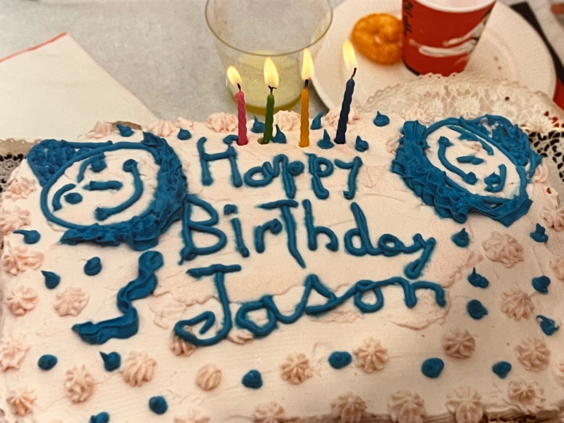 Happy Birthday Jason — candles glowing, smiley faces in blue icing, a cake made with love