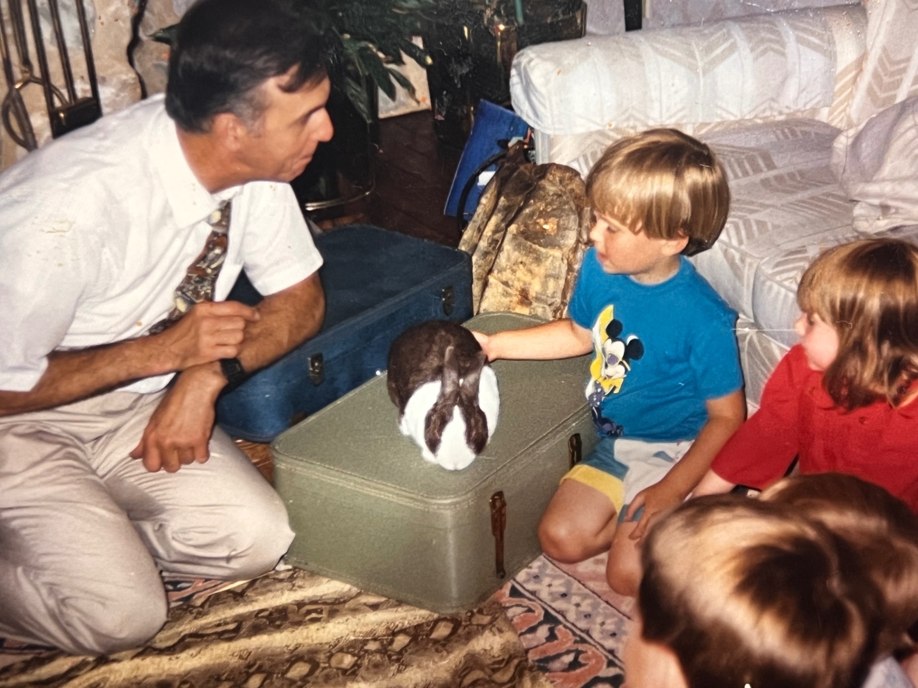The animal show birthday — Jason's dream. Richard made it happen because that's what he did for his boys. A rabbit on the trunk, everyone leaning in