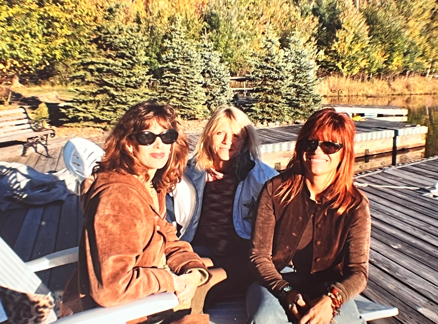 Yvonne with the girls on the dock — friends, fall light, and easy laughter at The Hideout