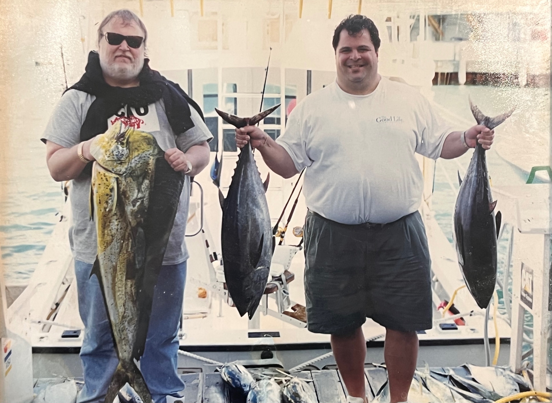 Richard and his best friend Bob D at the dock with the day's big catches — a huge mahi-mahi and two tuna. Deep sea days with his best buddy, the good life