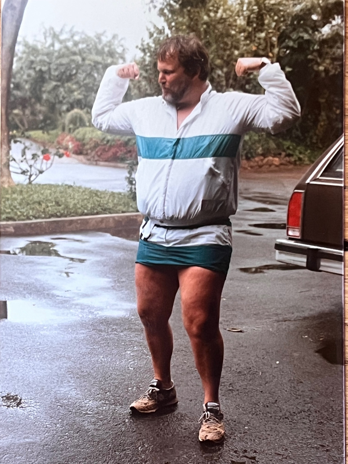Flexing in the rain — pure Richard energy, larger than life and loving every second