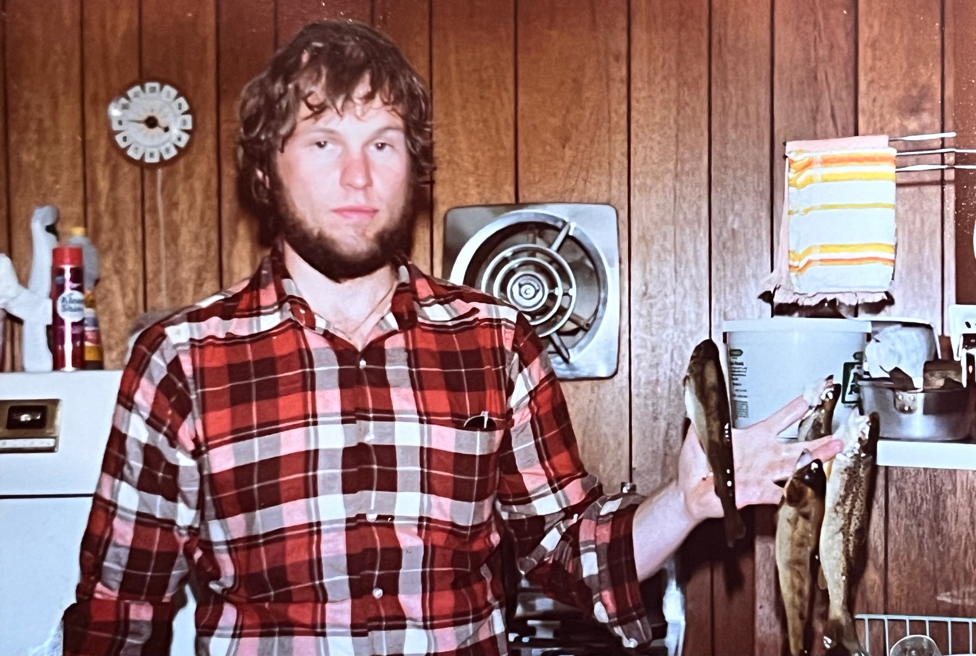 Deadpan and proud — Richard back at the apartment with two beauties from the day's catch. The stone-house dream still a few years off