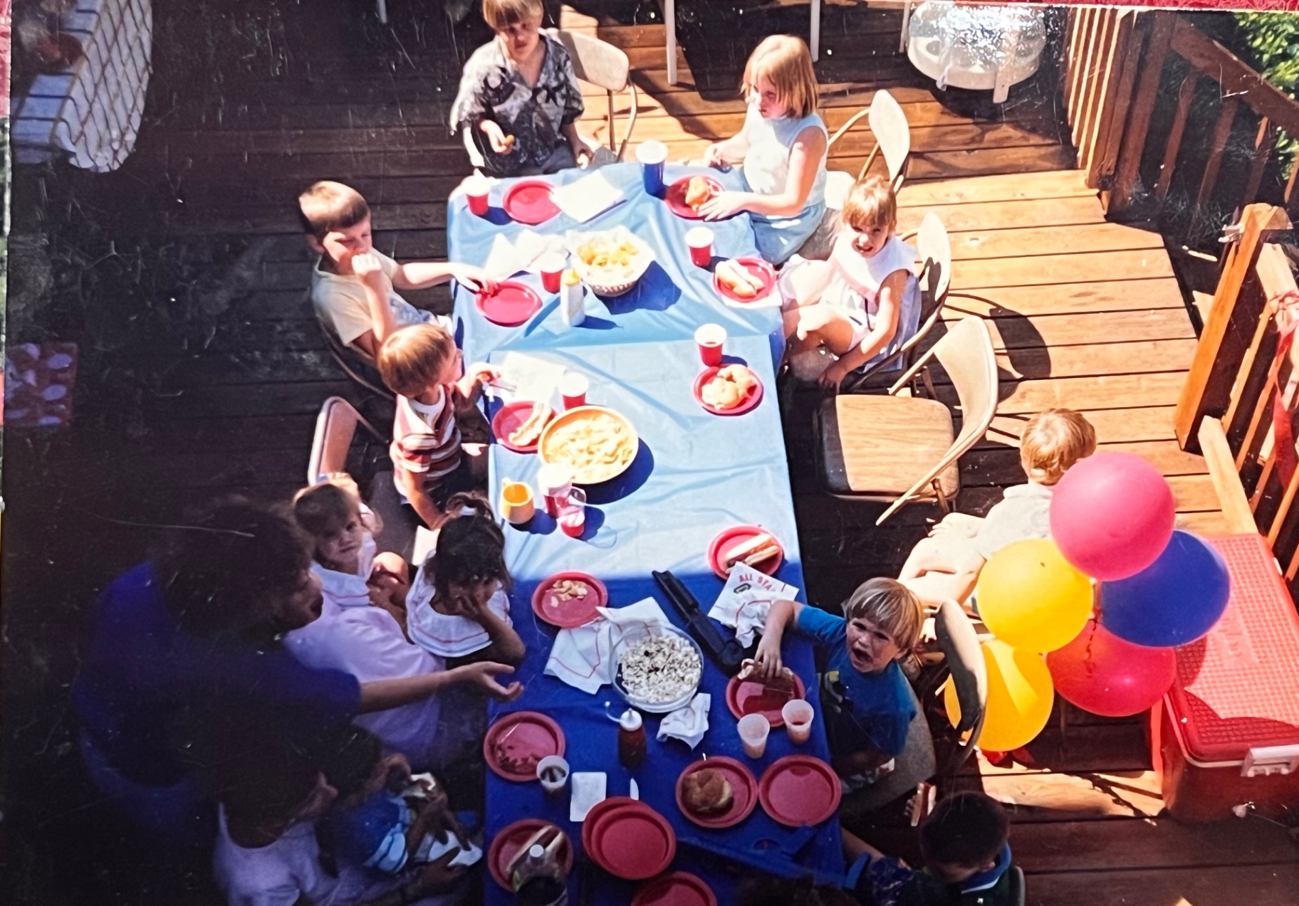 The deck packed with cousins and friends — hot dogs, popcorn, and a Bladis party in full color