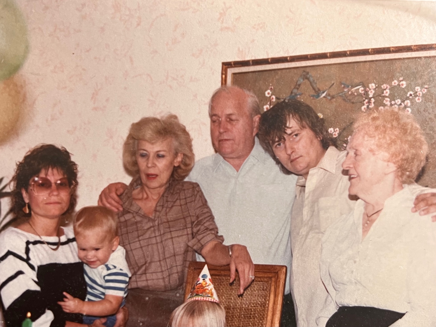Three generations gathered for a birthday — the whole crew shoulder to shoulder