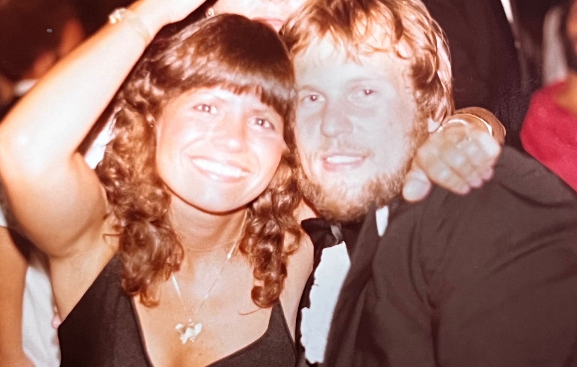 Yvonne and Richard on the dance floor — arm around his wife, biggest grins in the room. Newlyweds still glowing