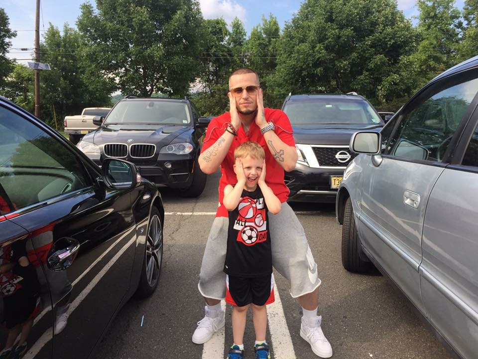 Dad and Sean — matching silly faces in the parking lot, pure joy caught mid-laugh