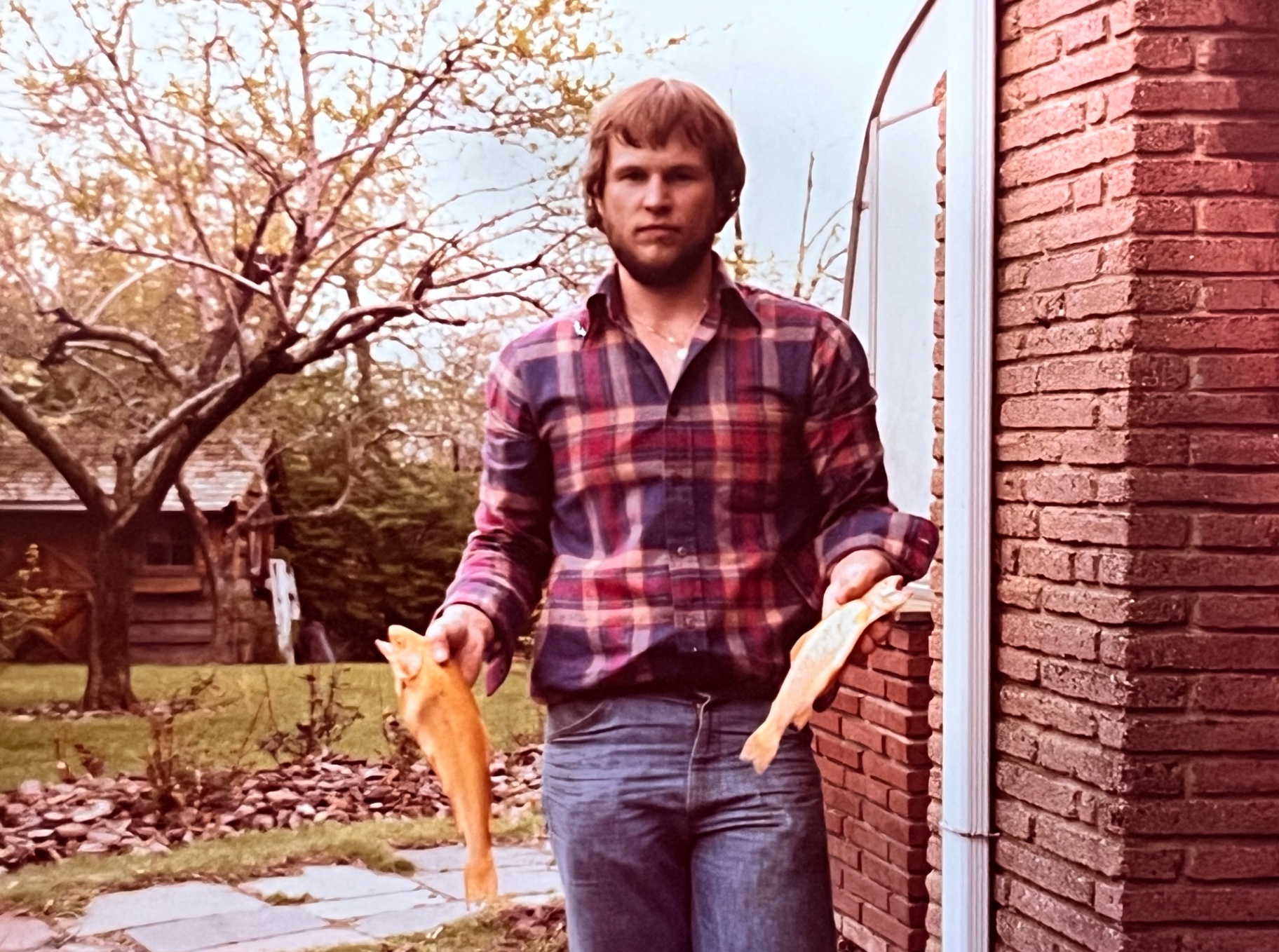 Two golden trout in each hand — Richard planting the pole on the Springfield stoop, the young sportsman before he became a dad