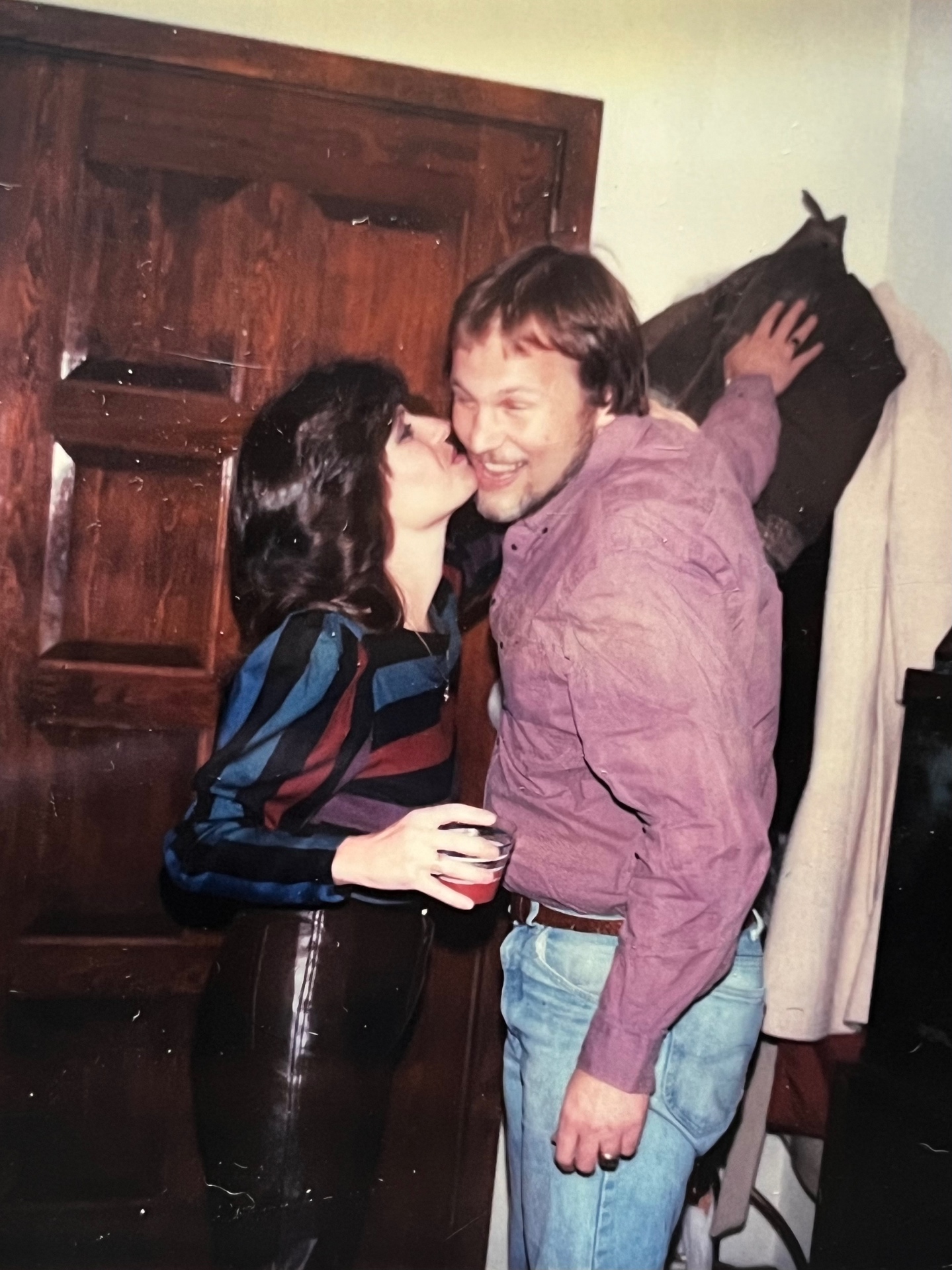 Yvonne sneaking a kiss — that grin says it all, young love and forever love in one frame