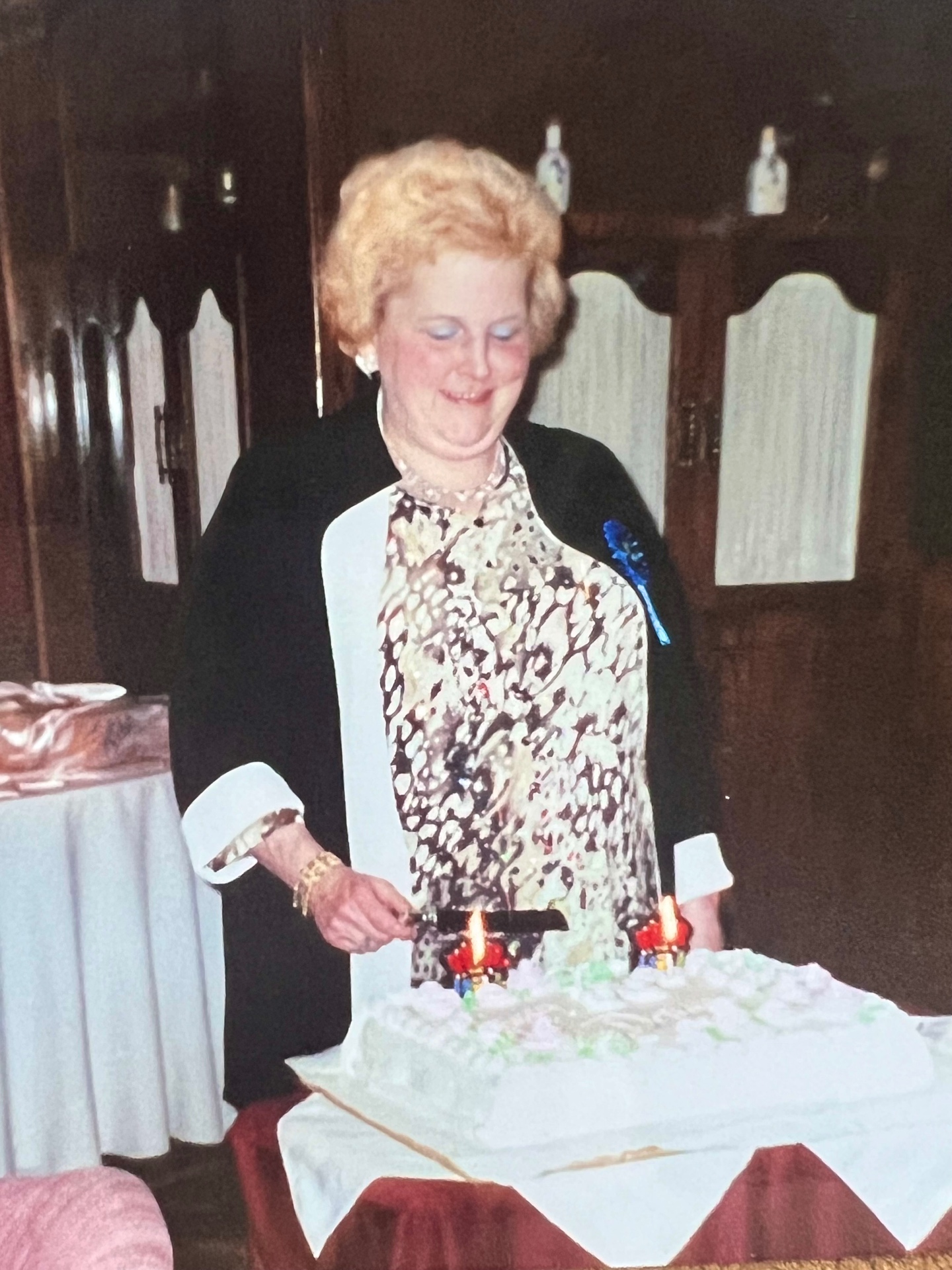 Richard's sister enjoying the celebrations — candles lit, cake ready, family gathered