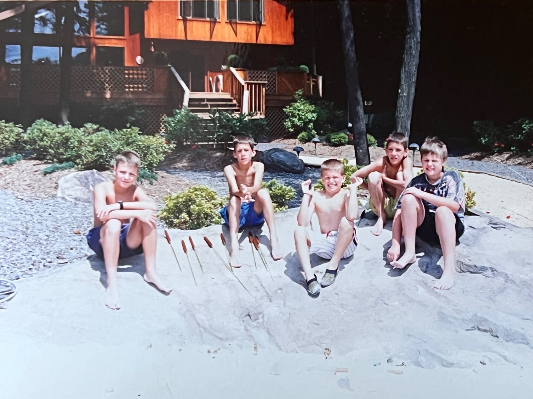 Summer at The Hideout — the kids gathered by the pool with the house in the background