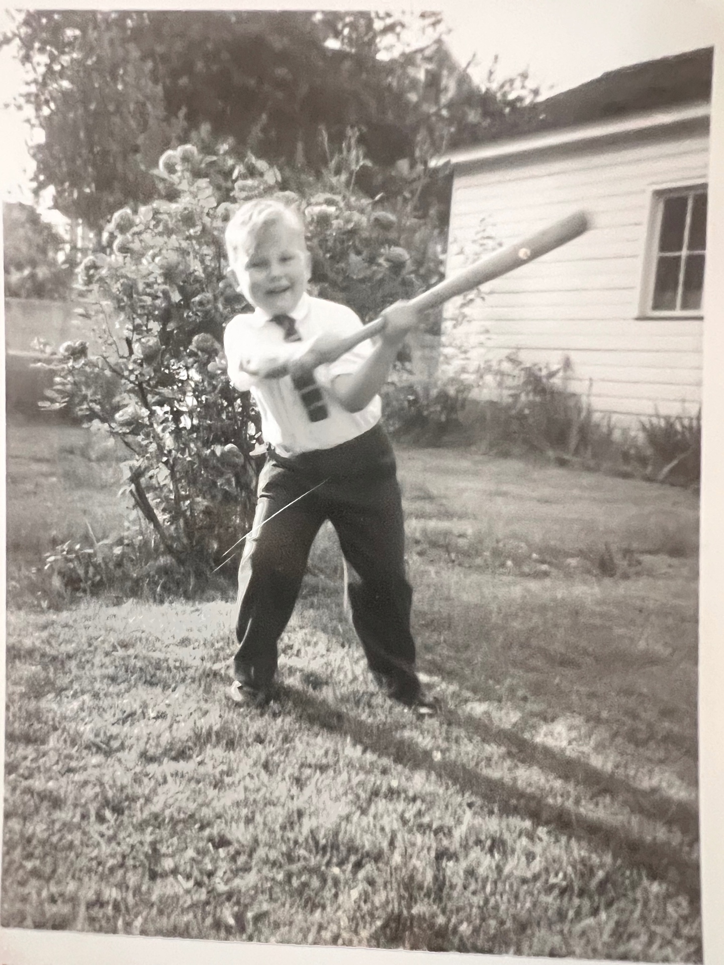 Little slugger in a tie — swinging for the fences in the backyard