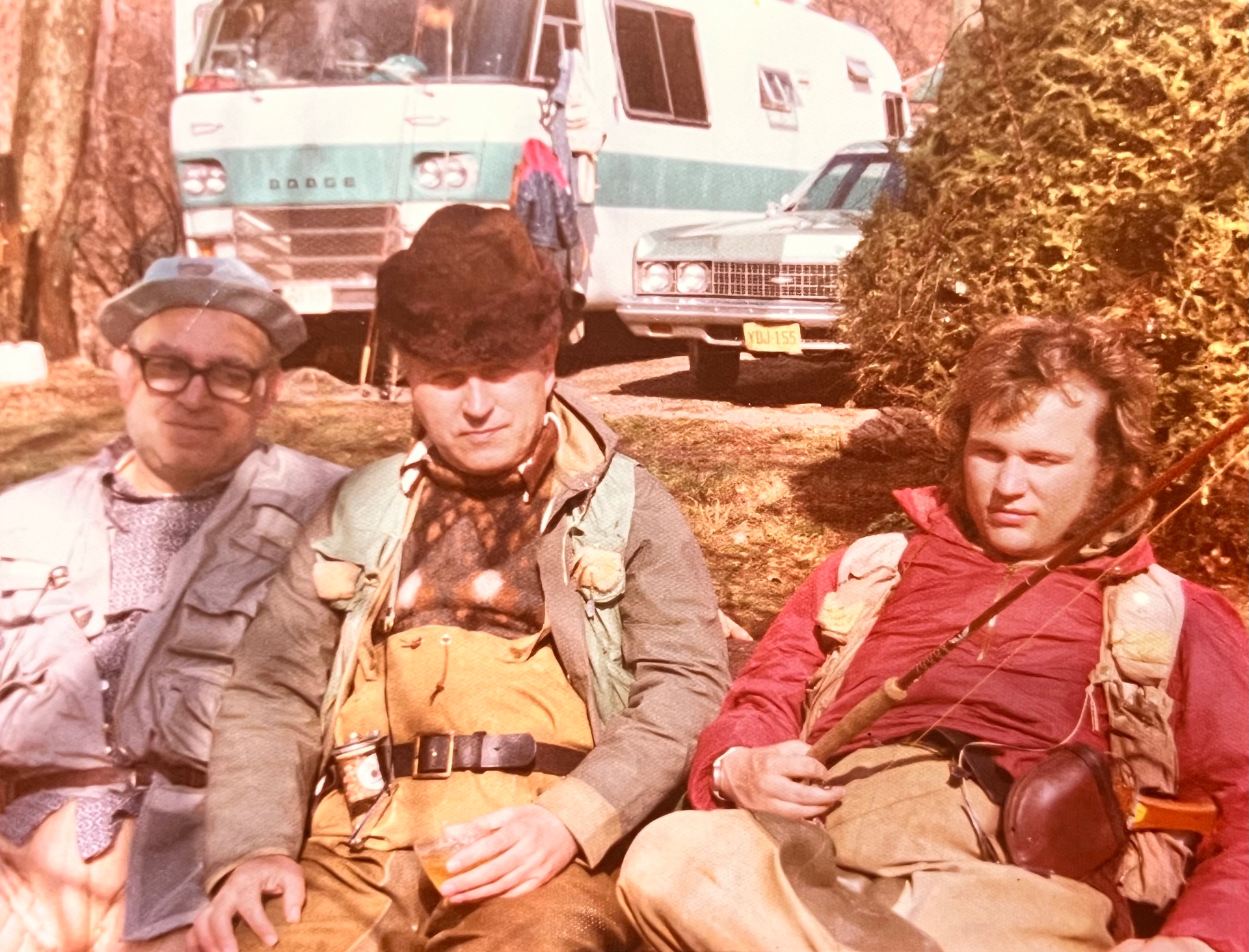Opening day with the guys — Richard on the right, his dad and a buddy resting after the morning run, the Dodge motorhome parked behind. Pure 1970s