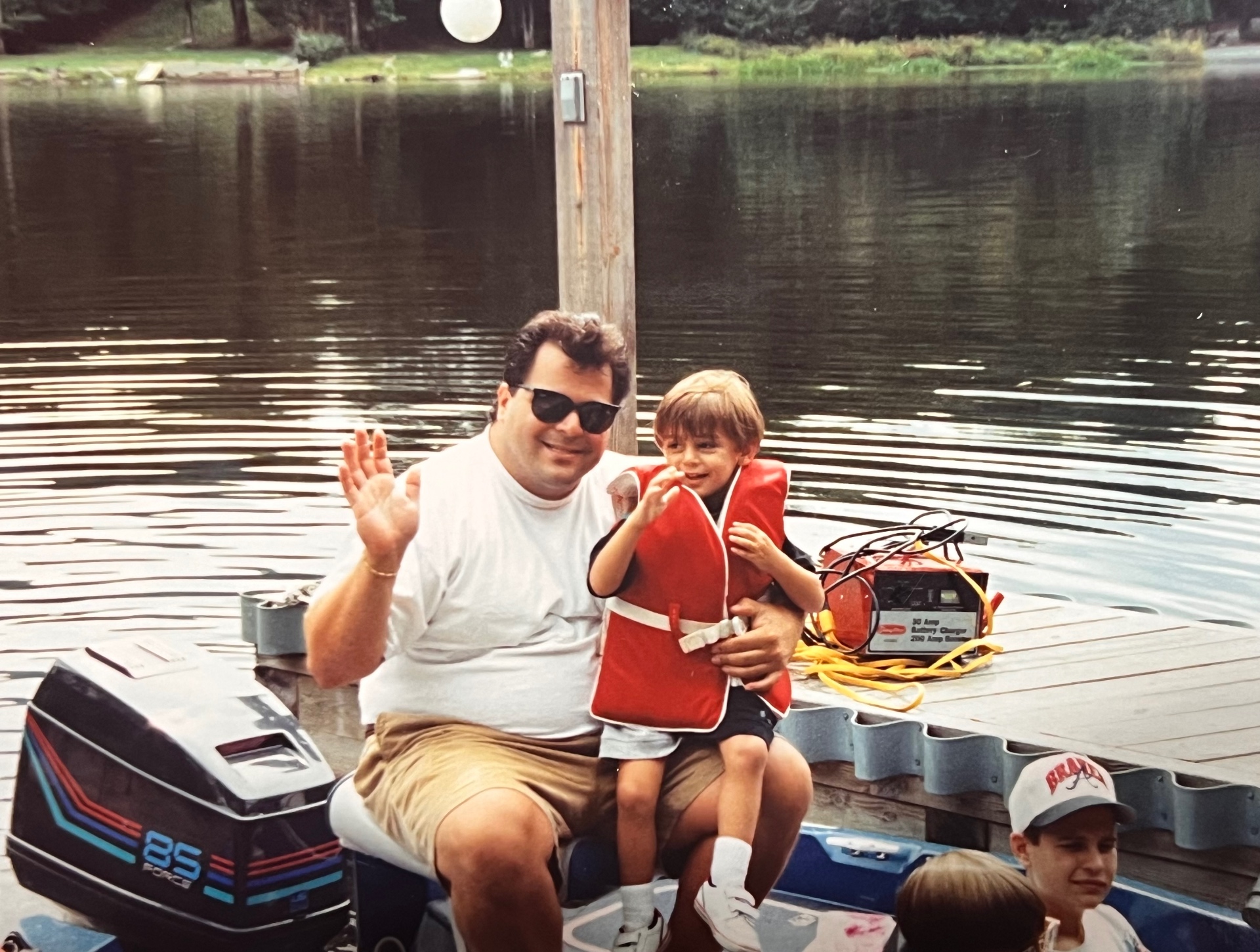 Bob D and his son Francis dockside at The Hideout — best friends becoming family, one lake day at a time