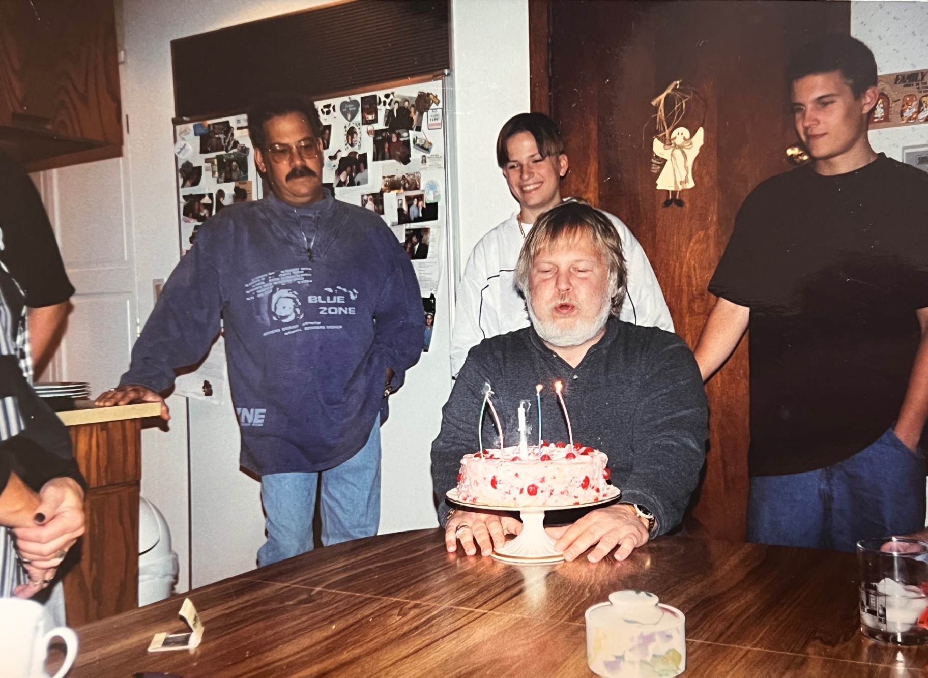 Richard blowing out his candles — the boys and family gathered around, exactly the way he loved it