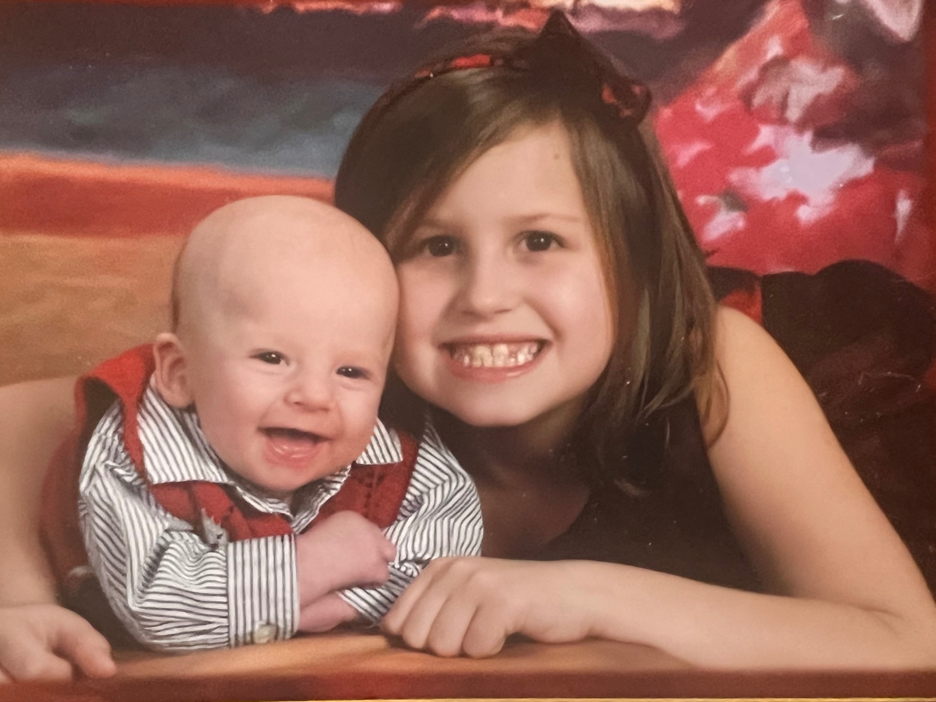 Malayna and baby Sean — big sister smile, little brother giggle. Richard loved watching them grow up together