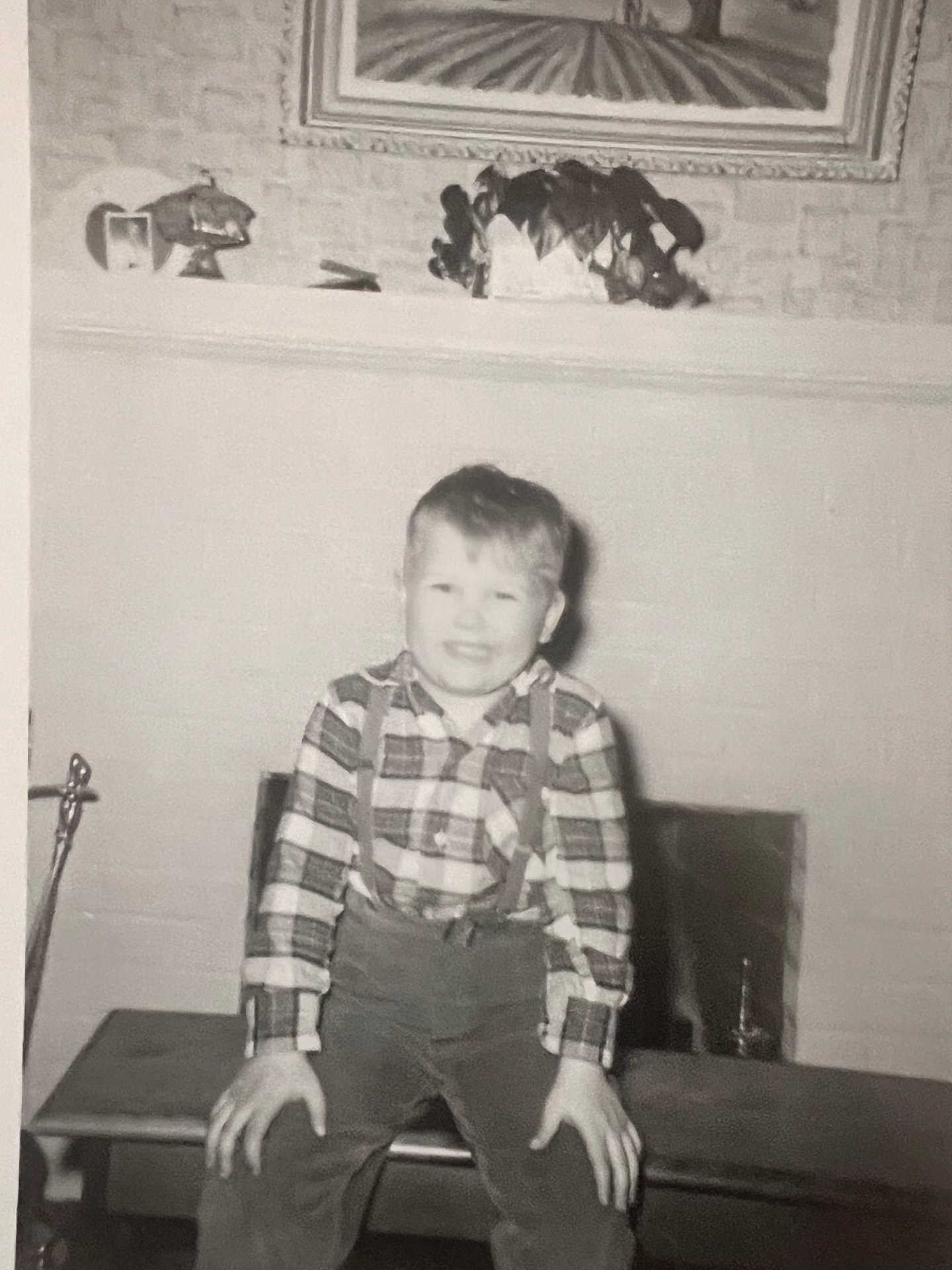 Little Richard by the fireplace — plaid, suspenders, and a grin that never left him
