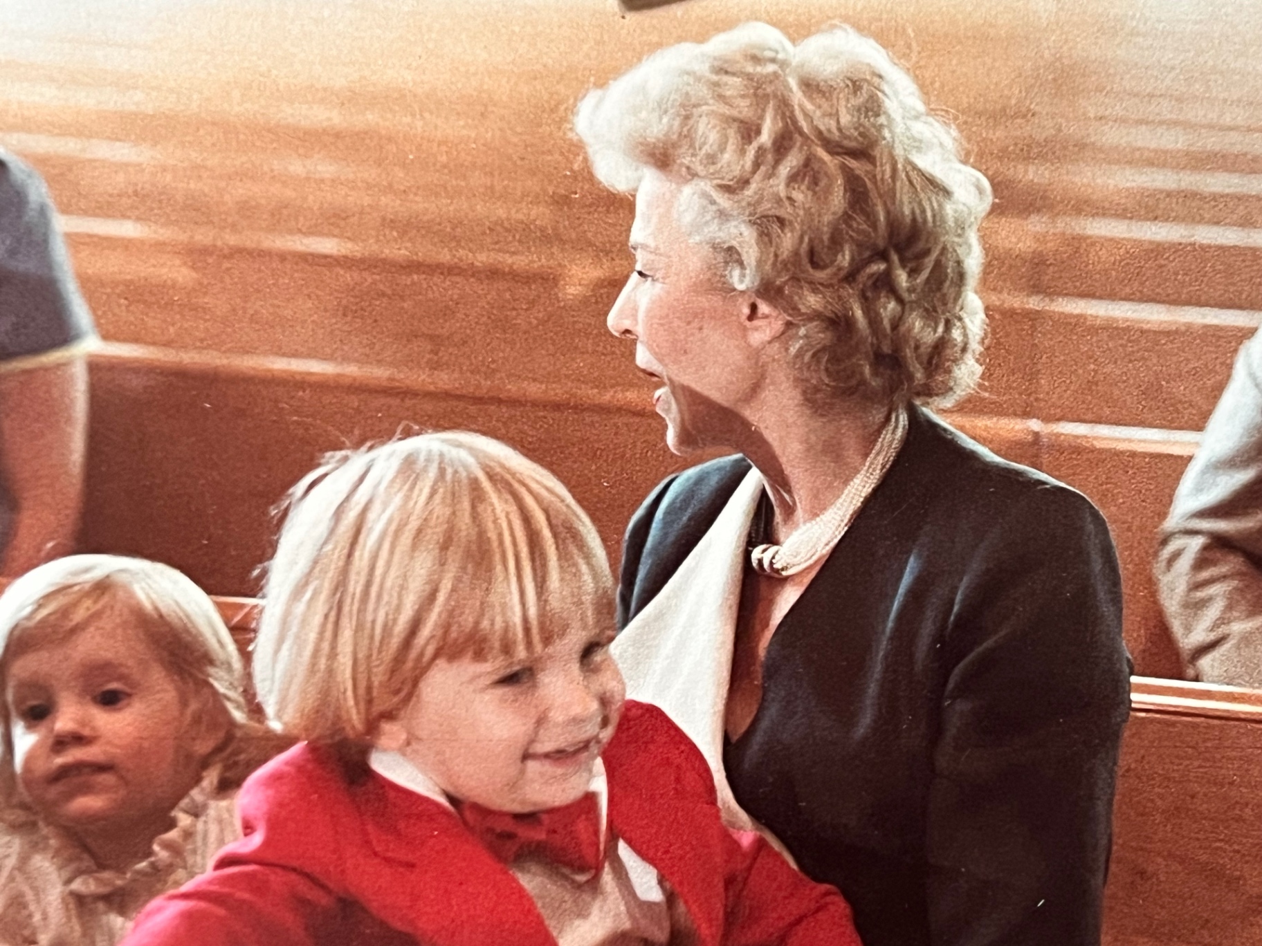 Gloria with a grandchild in Sunday best — laughter in the pews