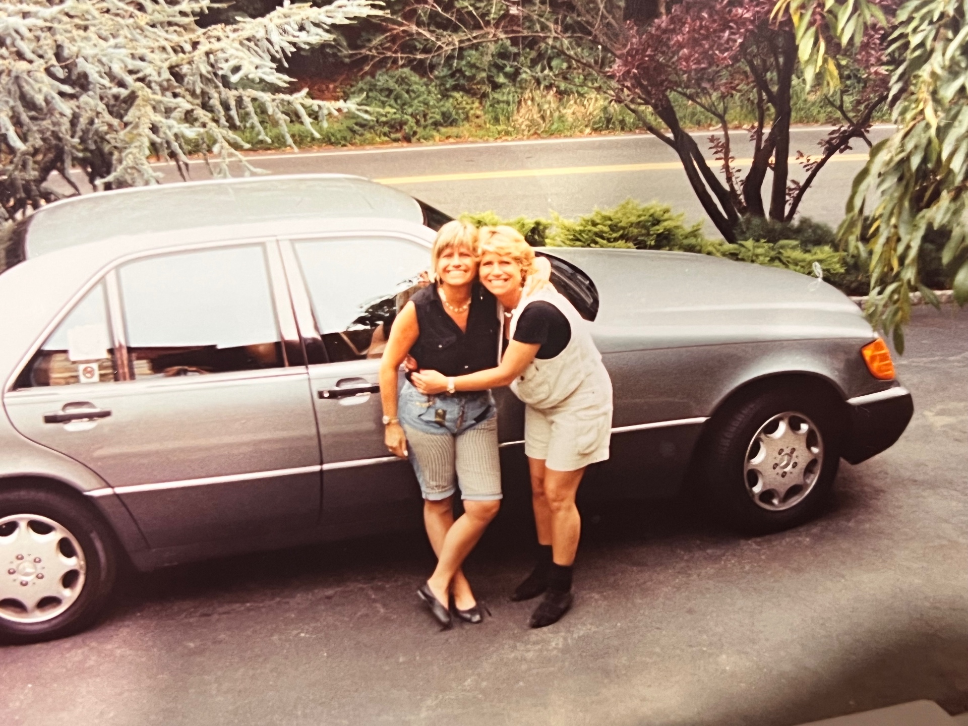 Yvonne with her sister Renee Arnold beside the new Mercedes-Benz in the Mountainside driveway — sisters, side by side