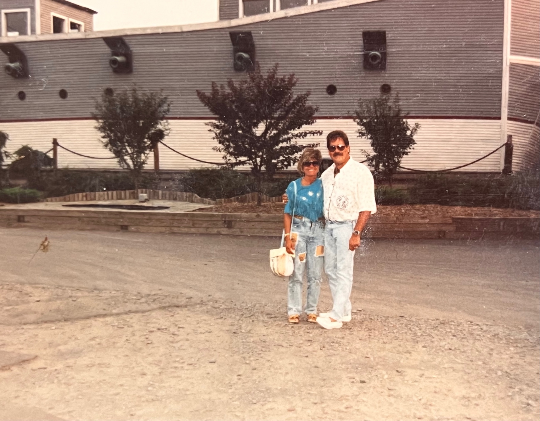 Richard and Yvonne dockside by the old ship — every trip a memory made together