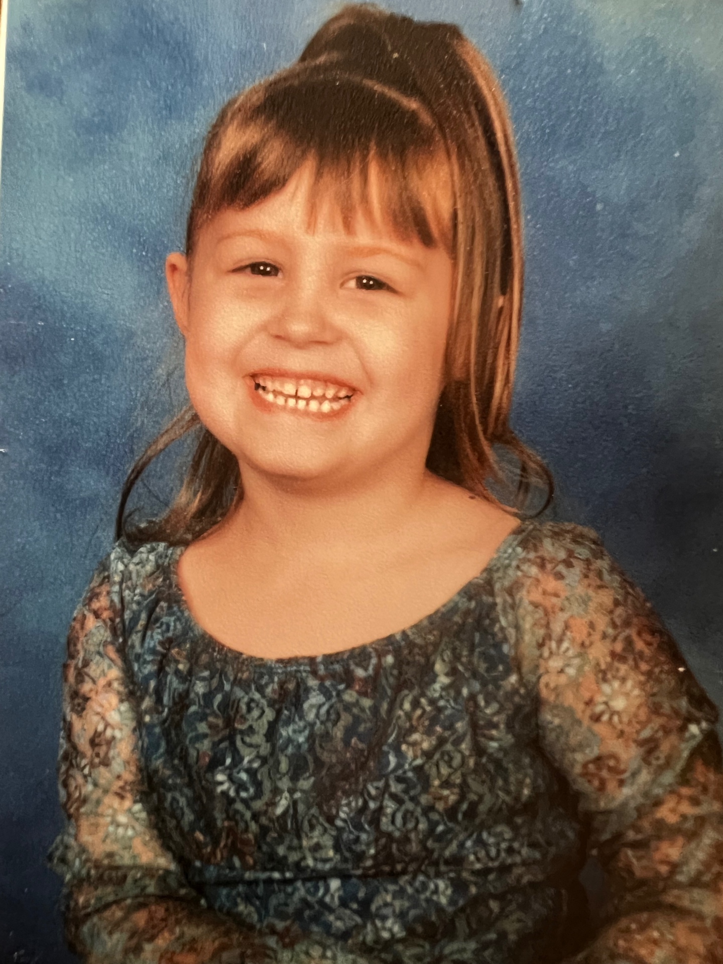 Malayna — Richard's granddaughter, all smiles in her school portrait