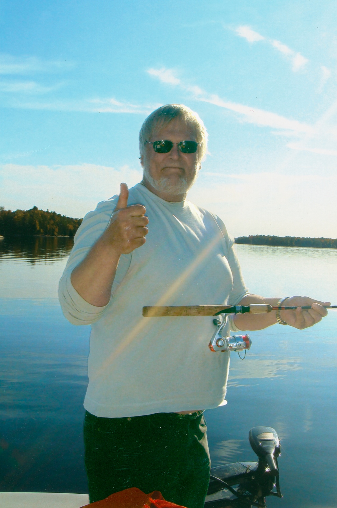 Thumbs up on a glass-calm morning — Richard in his element on the Canadian waters he loved