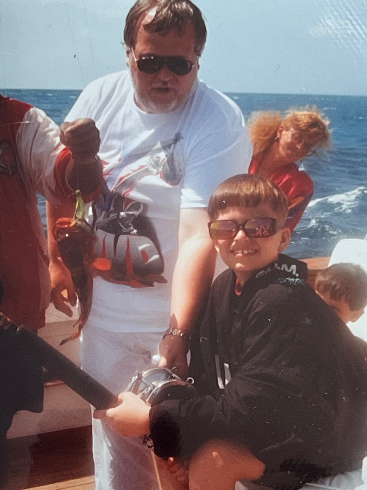 Deep sea day with his son on the reel — Richard beside him, guiding every crank