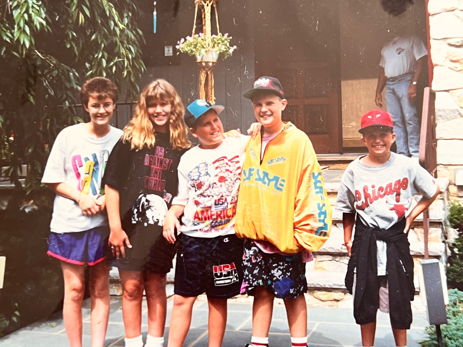 The whole cousin crew on the front step — '90s summer, big smiles, unforgettable years