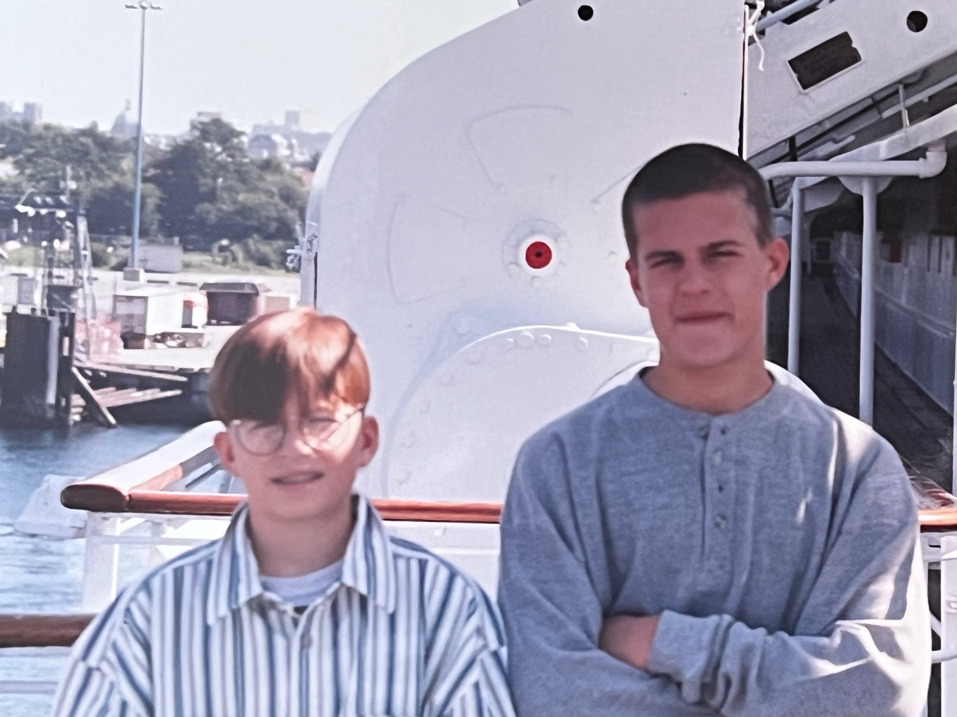 The boys on deck during a family cruise — windblown hair, bright light, and miles of adventure ahead