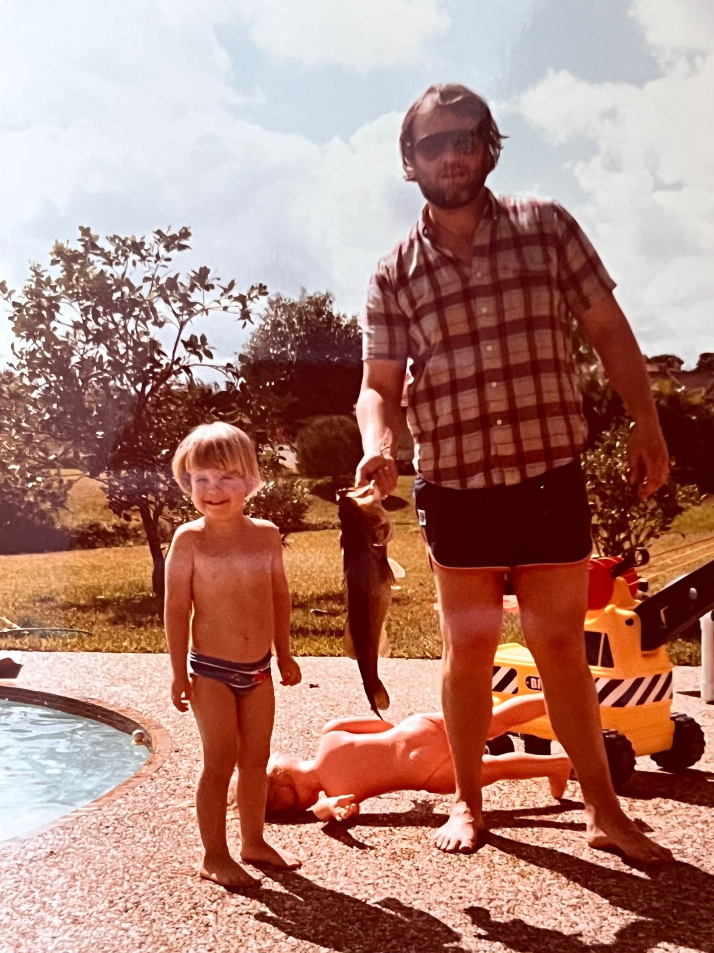 Poolside with the little man and the day's bass — Florida sun, best kind of afternoon