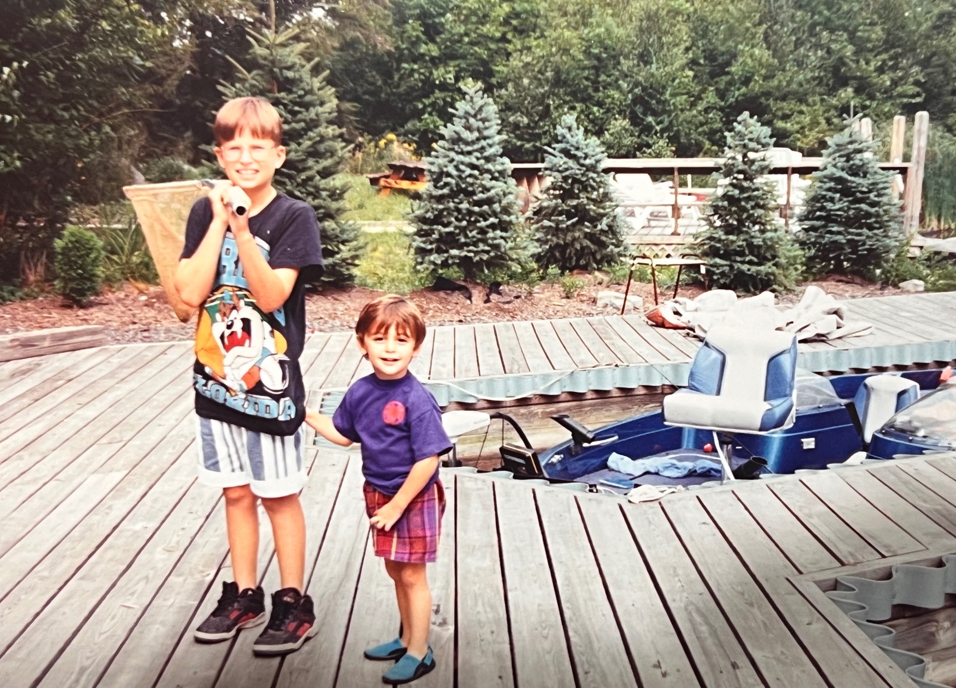Jason and Francis on the dock — little cousins, big smiles, that Hideout summer feeling