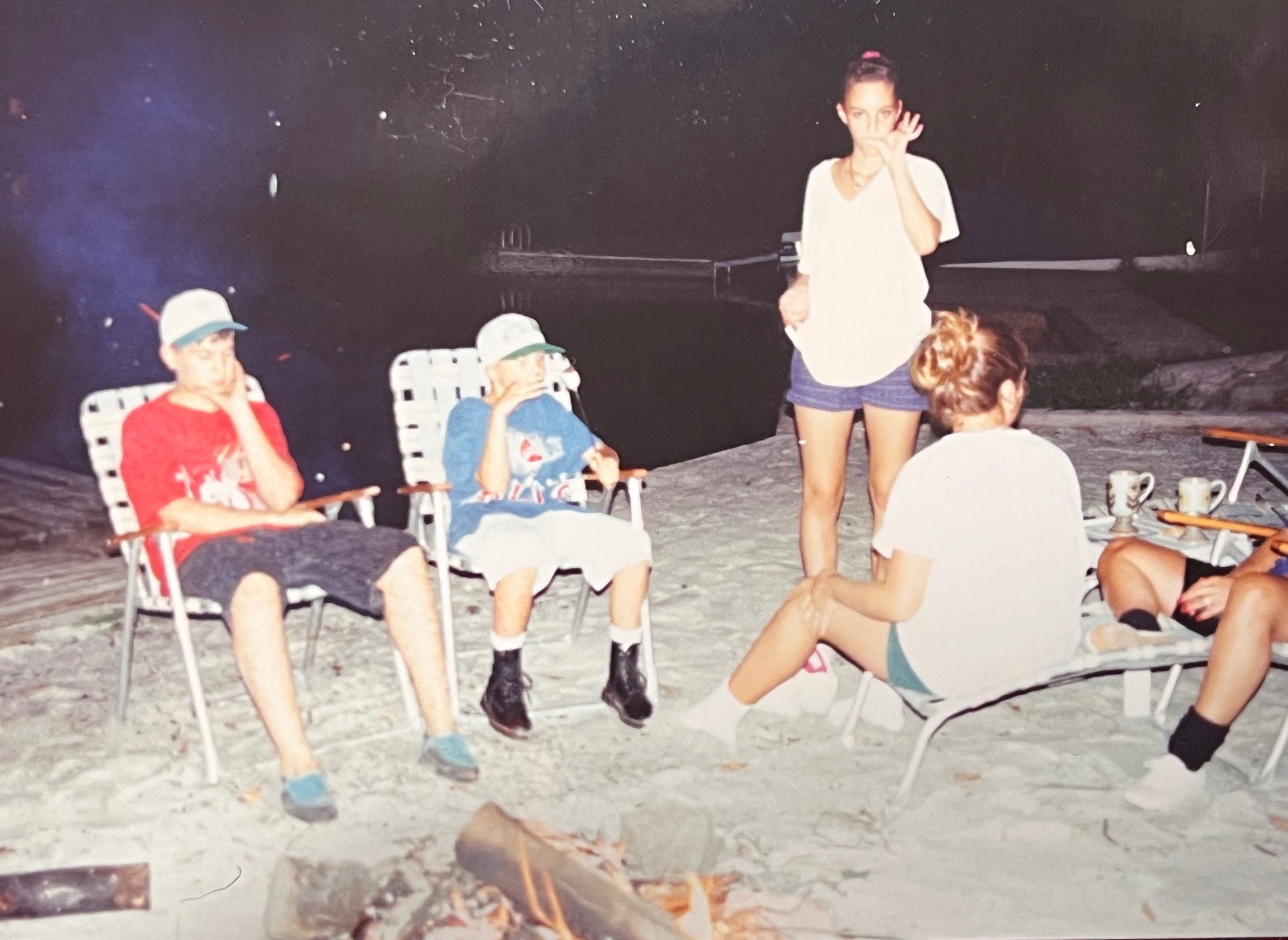 Beach firepit nights by the dock — Chris, Jason, and the cousins gathered around the flames while Richard was probably up at the house with his buddies, getting ready for another sunrise fishing expo